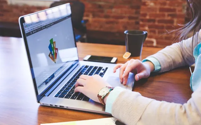 Pessoas com notebook e computador no escritório